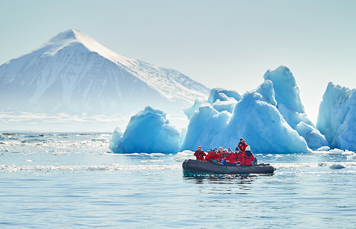 Guests in RIB boat navigating through icebergs