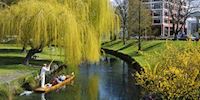 People riding in a gondola on the Avon river in Christchurch, Australia