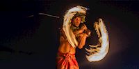 A fire dancer performing at a Luau